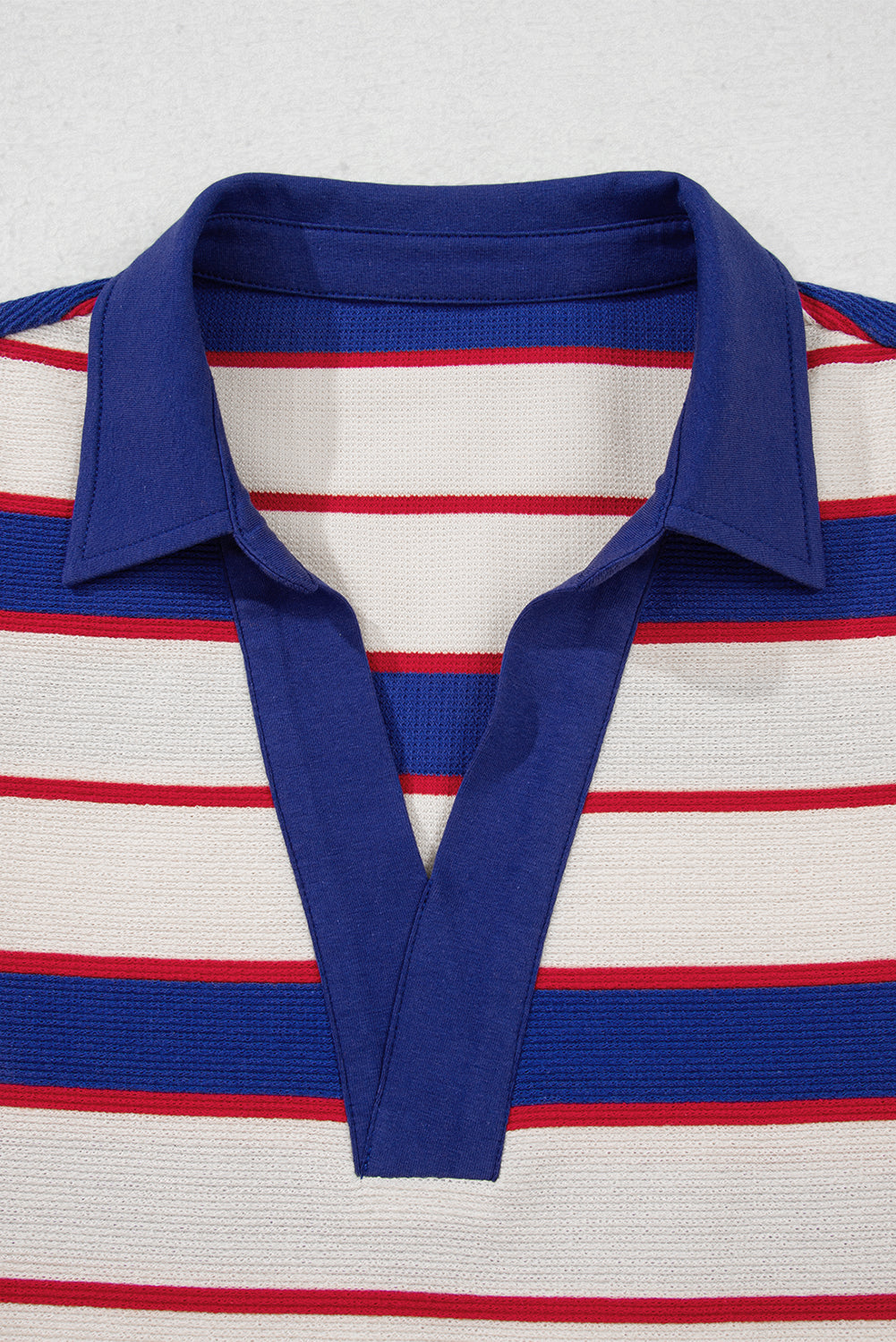 Lifestyle shot of wearing Genesis Stripe Polo Pullover in casual setting