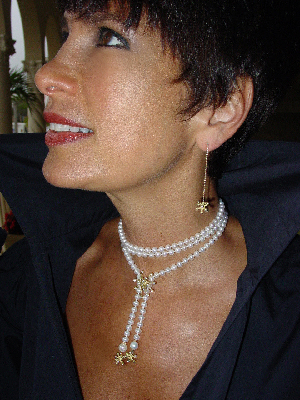 Close-up of the luxurious 18K Pearl Lariat showcasing sparkling diamonds