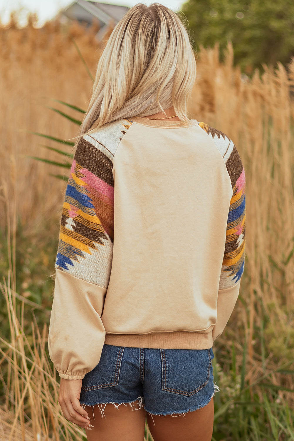 Side angle of Logan Aztec Patchwork Raglan Sweatshirt showcasing unique design by Threaded Pear