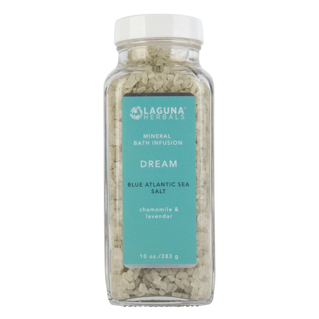 Relaxing bath scene featuring Laguna Herbals Dream Mineral Bath Salt with lavender flowers