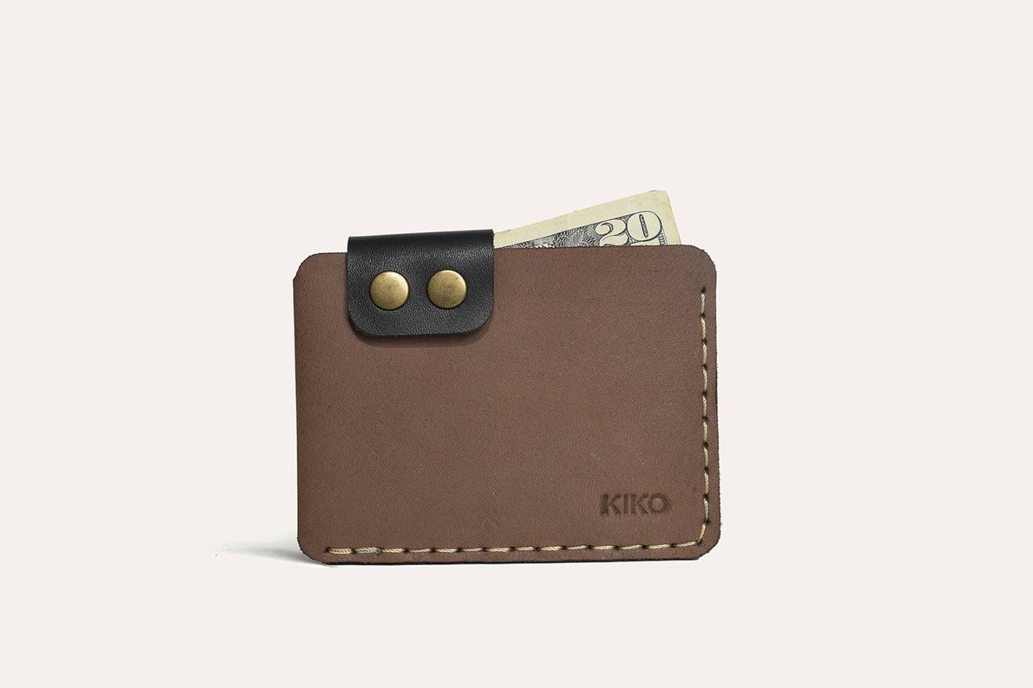 Hand holding Kiko Slim Card Wallet showing its compact design