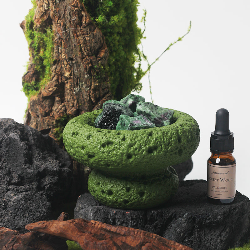 Green Moon Diffuser placed on a stylish table with greenery