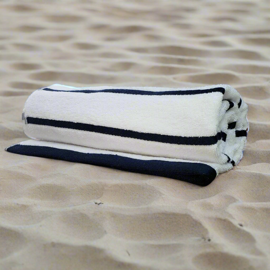 Lifestyle shot of Nautical Stripes Pool Towels on a beach chair