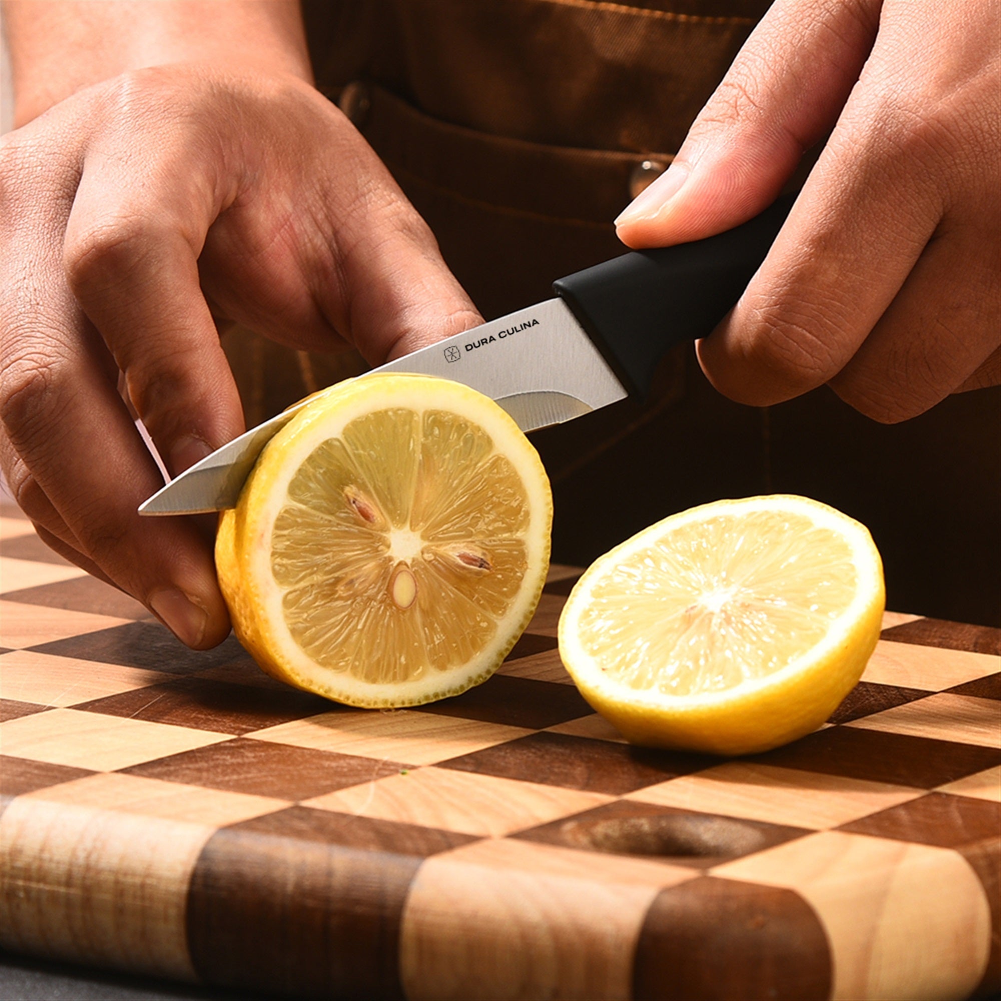 Side view of Dura Living kitchen knife set on a wooden cutting board