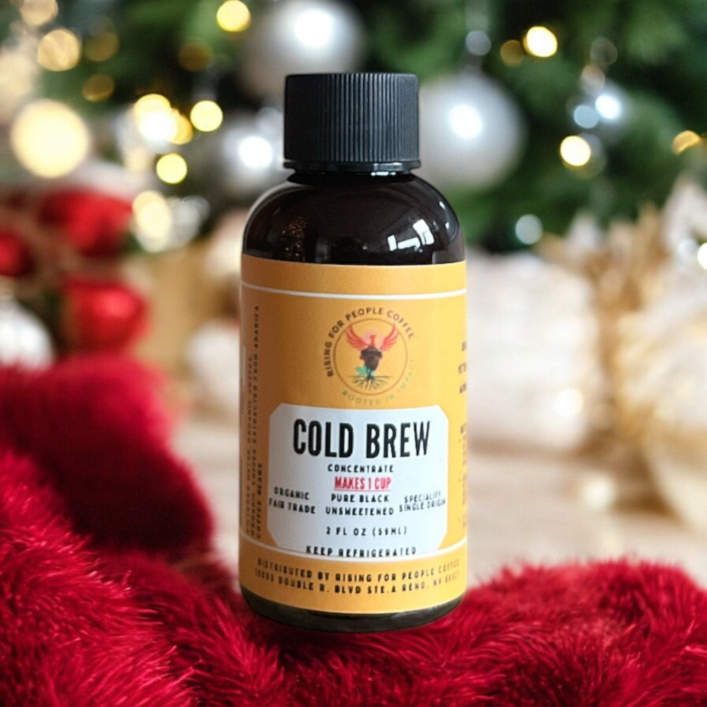 Pouring Organic Cold Brew Coffee Concentrate into a glass filled with ice.