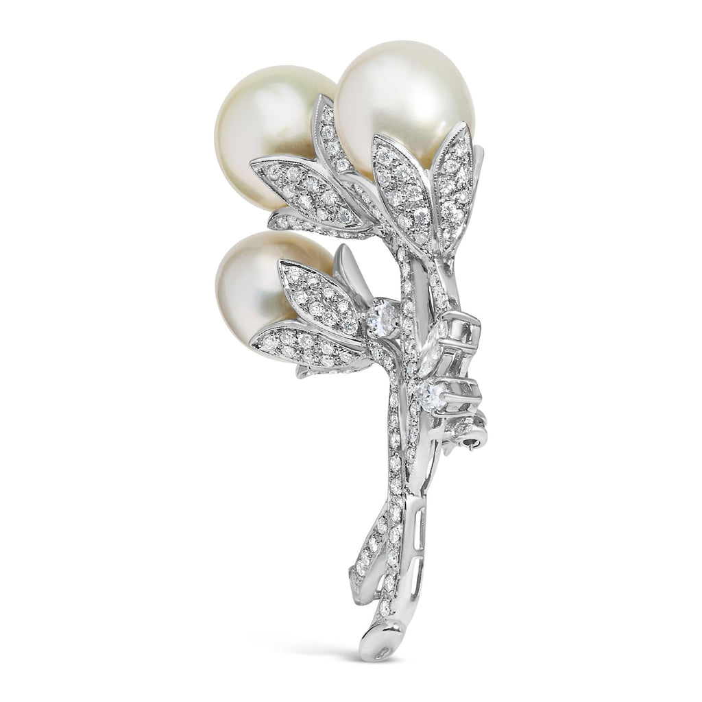 Showcase of the luxurious 18K White Gold Floral Brooch with sparkling diamonds