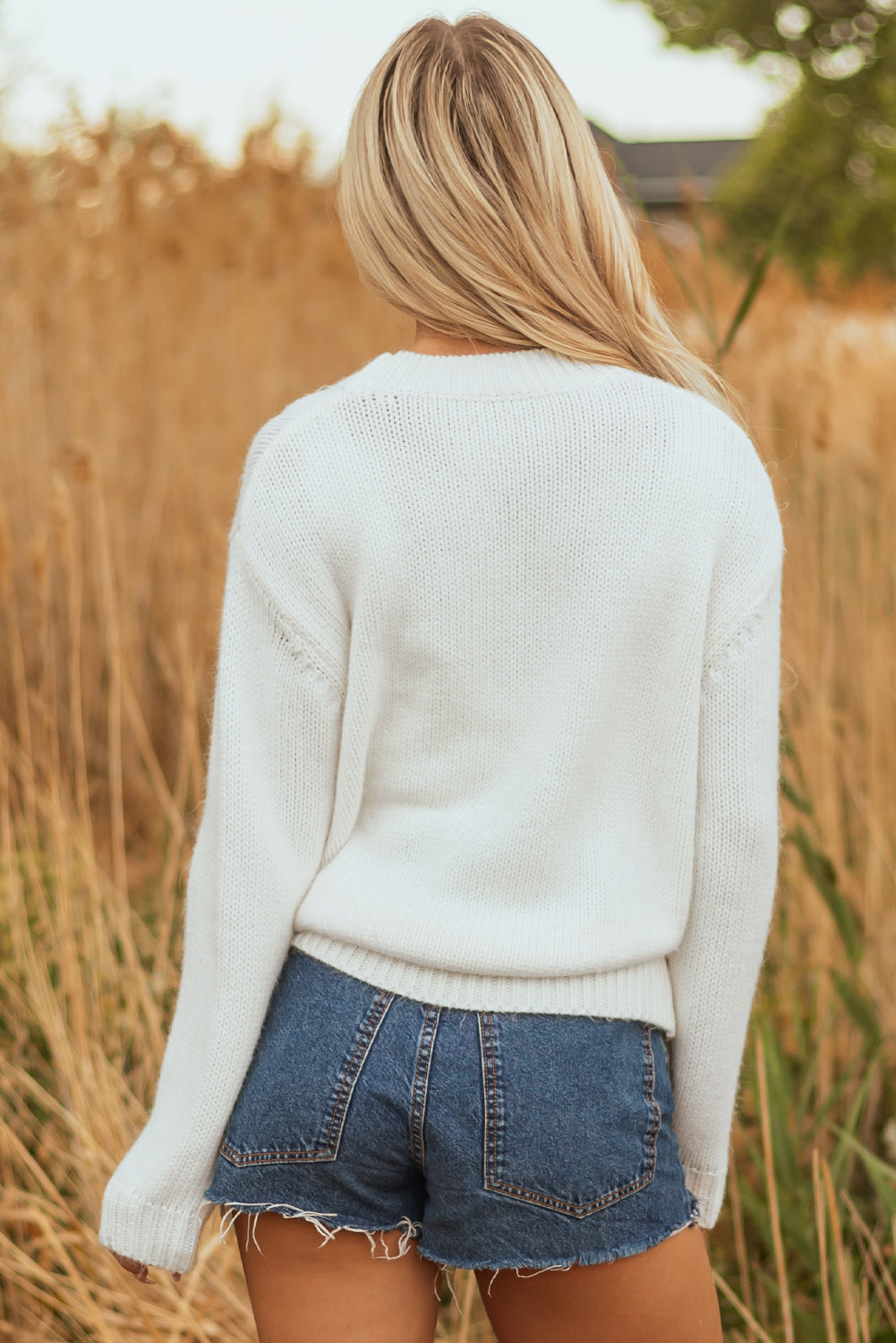 Side view of Cozy Amanda Bow Boots Sweater showcasing embroidery by Gobingya