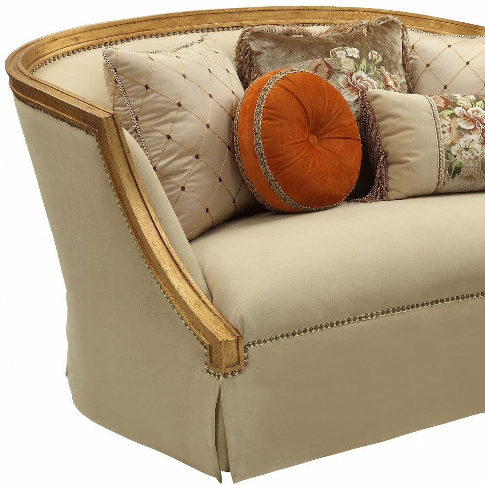 Living room setting with Tan and Gold Curved Loveseat