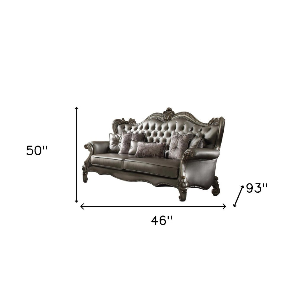 Matching toss pillows included with the 46" Platinum Faux Leather Curved Sofa