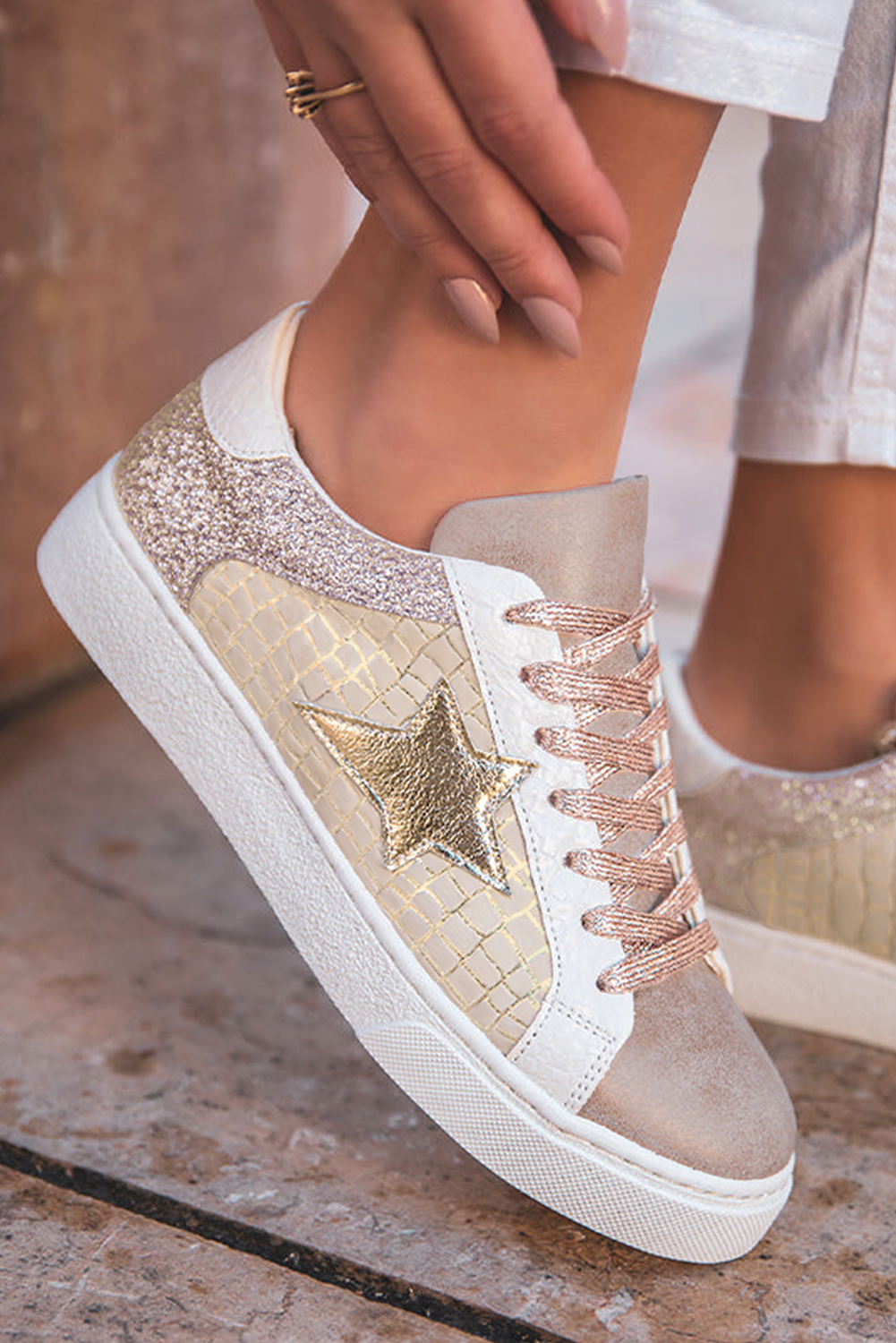 Stylish flat lay of Gold Star Lace-Up Sneakers by Threaded Pear