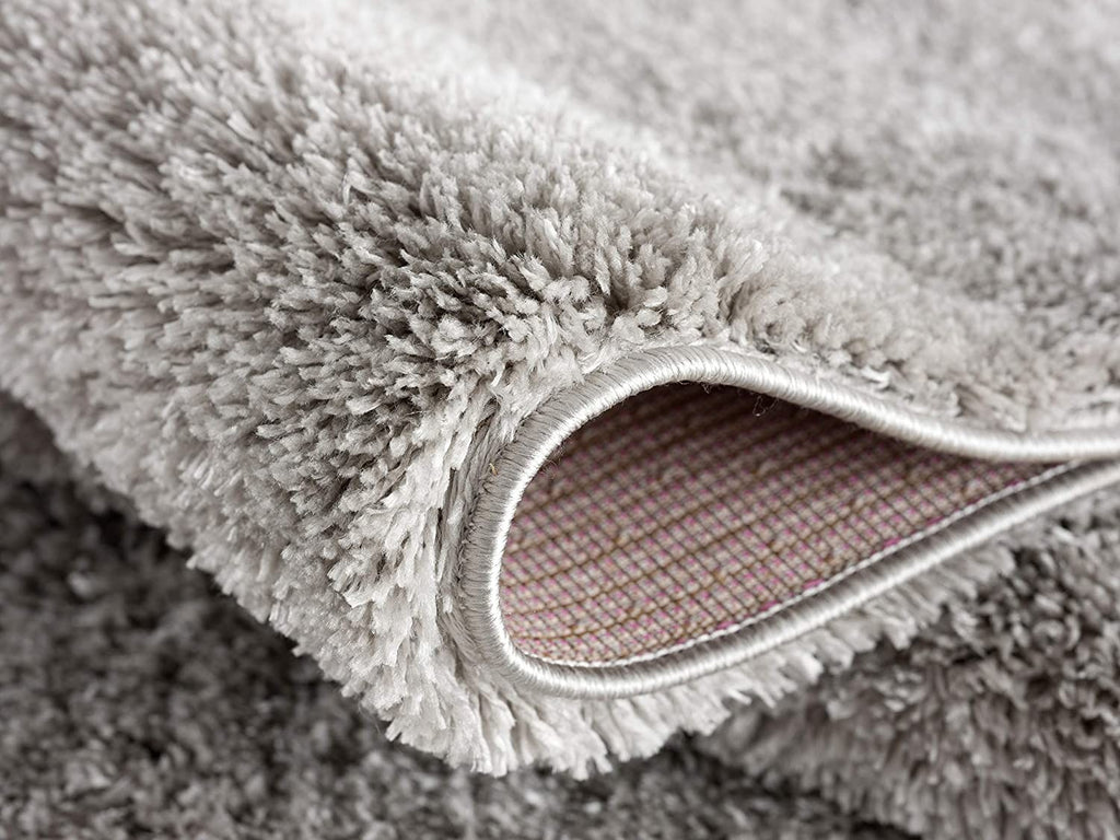 Cozy corner featuring the Ivory Modern Solid Shag Area Rug by Homeroots