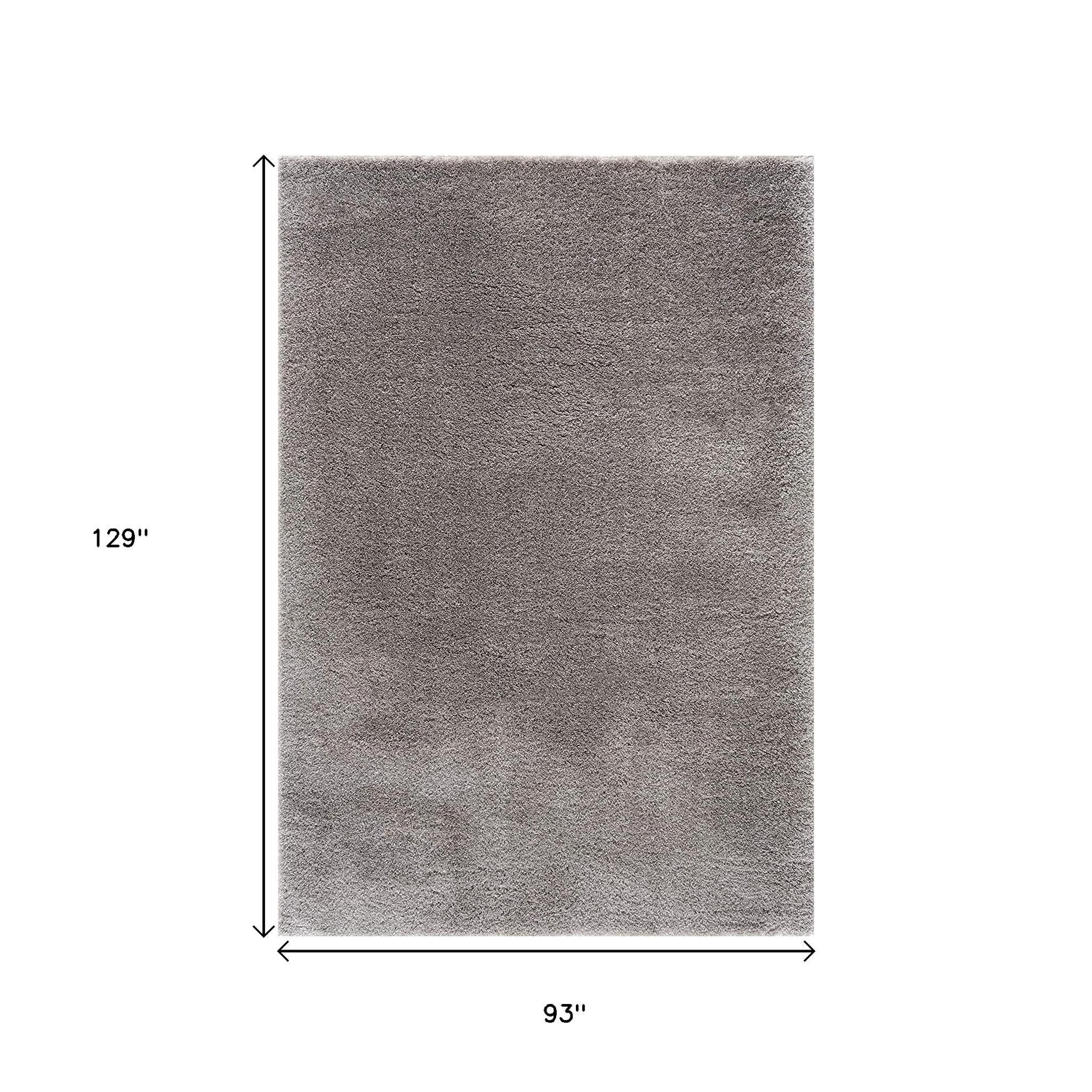 Living room setting with 8' x 11' Ivory Modern Solid Shag Area Rug