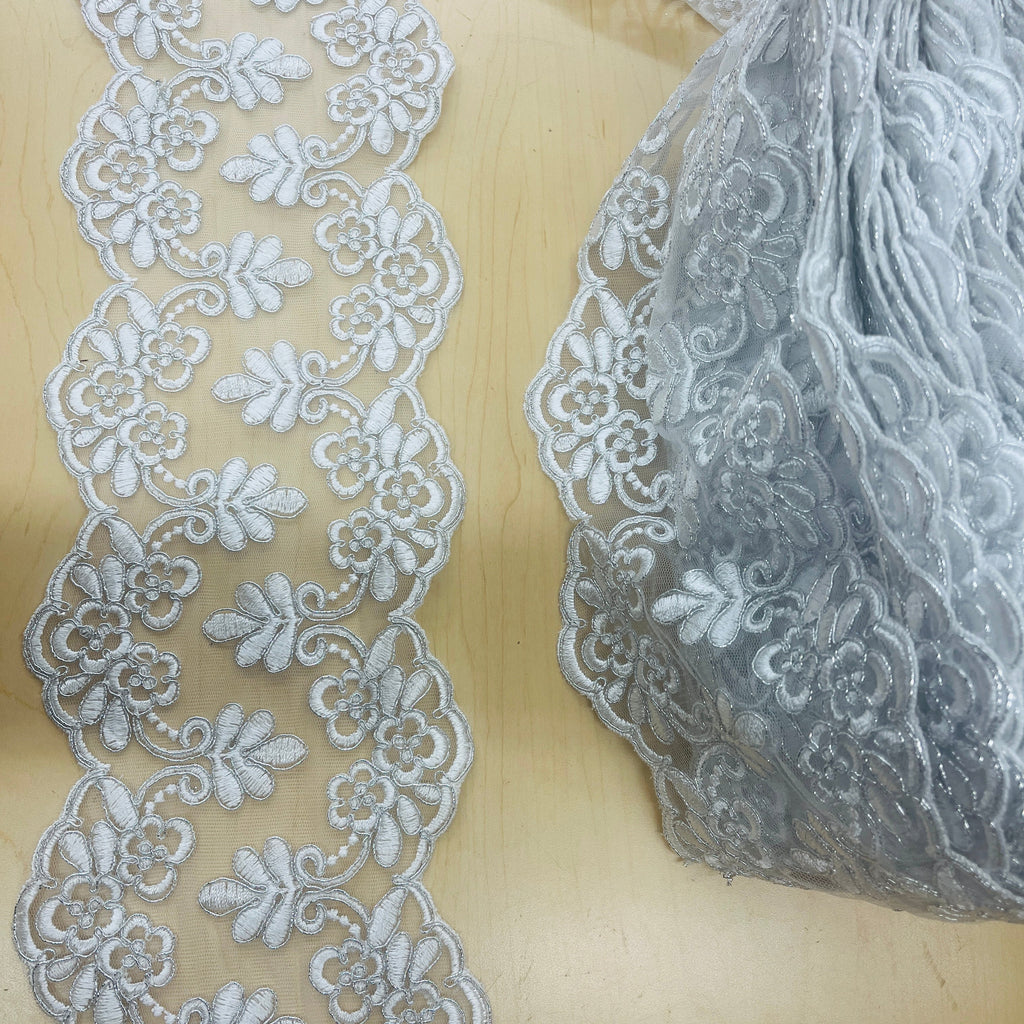 Elegant Double-Sided Floral Lace Trim draped on fabric
