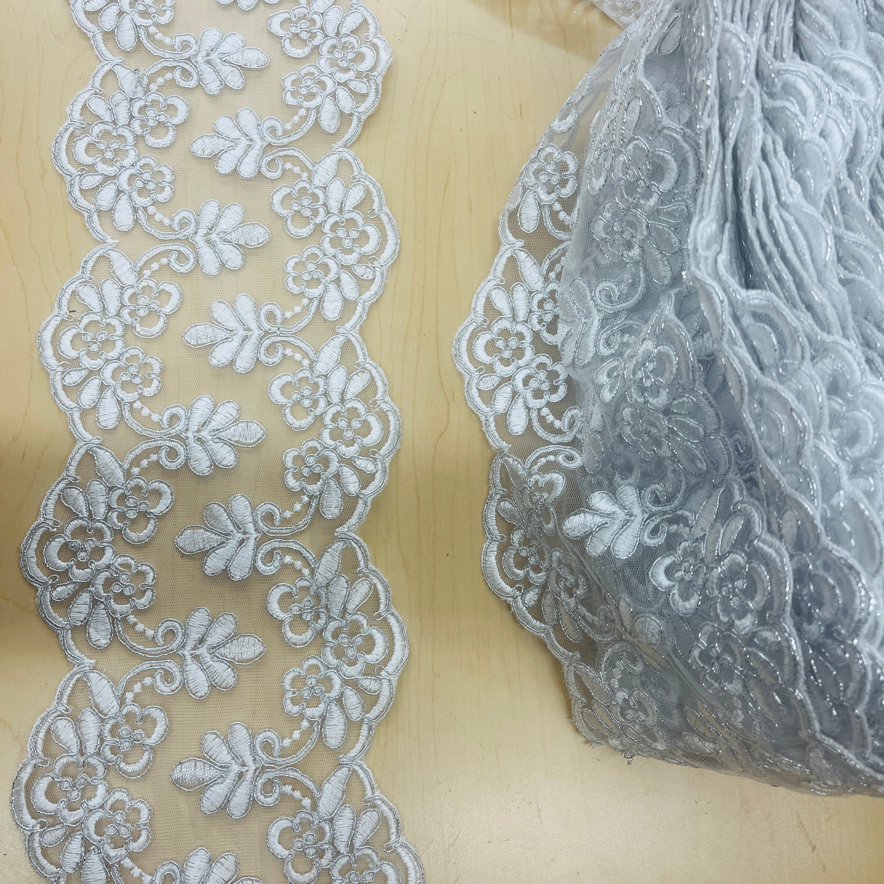Elegant Double-Sided Floral Lace Trim draped on fabric