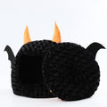 Side view of the Cozy Halloween Devil Den Pet Bed with playful design