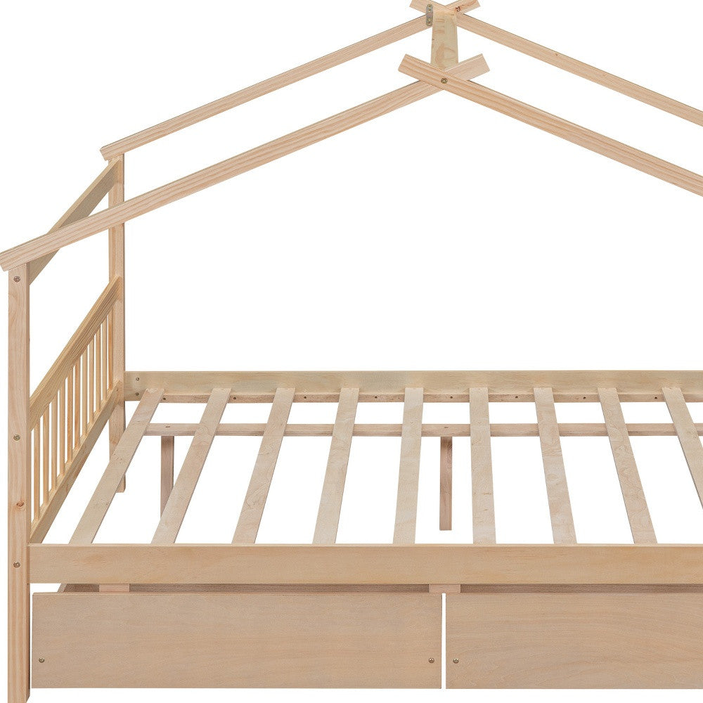 Storage drawers of the natural wood full canopy bed frame open for access