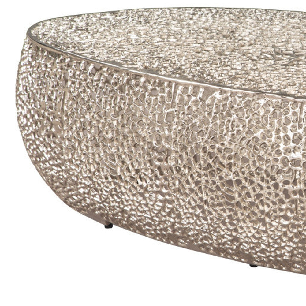 50" Silver Aluminum Oval Coffee Table with chairs in stylish setting