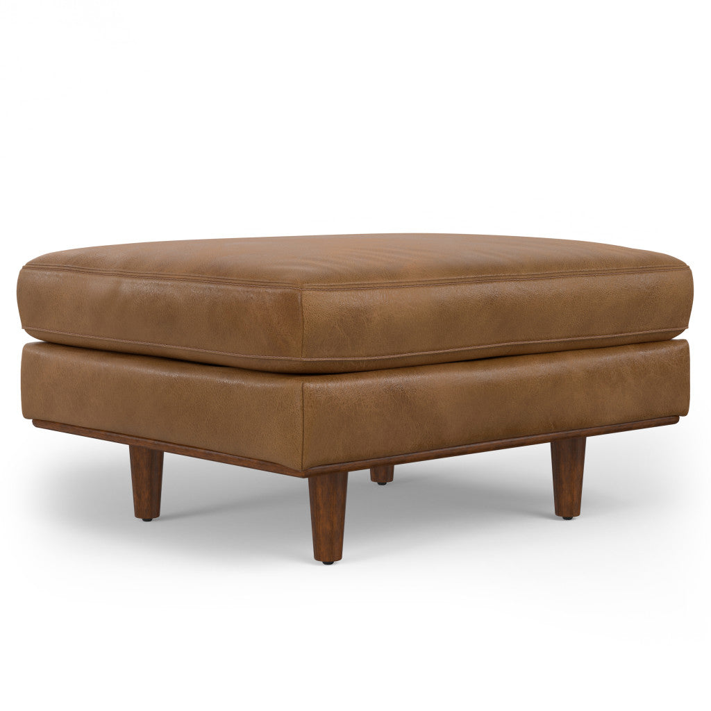 Brown leather cocktail ottoman used as a coffee table with drinks