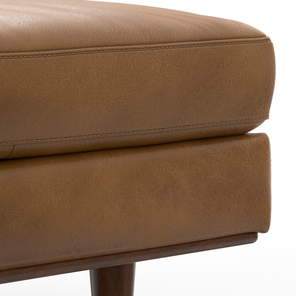 Side view showcasing the elegant design of brown leather ottoman