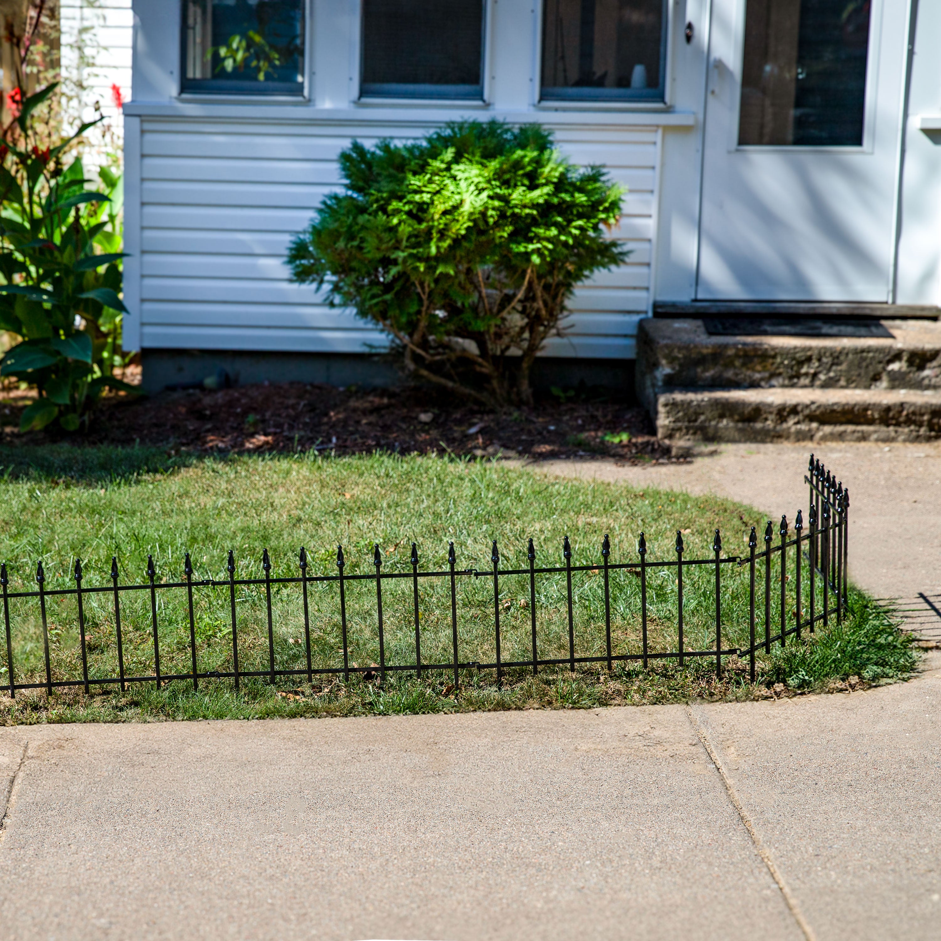 Traditional-style Black Iron Garden Stake in a flower bed
