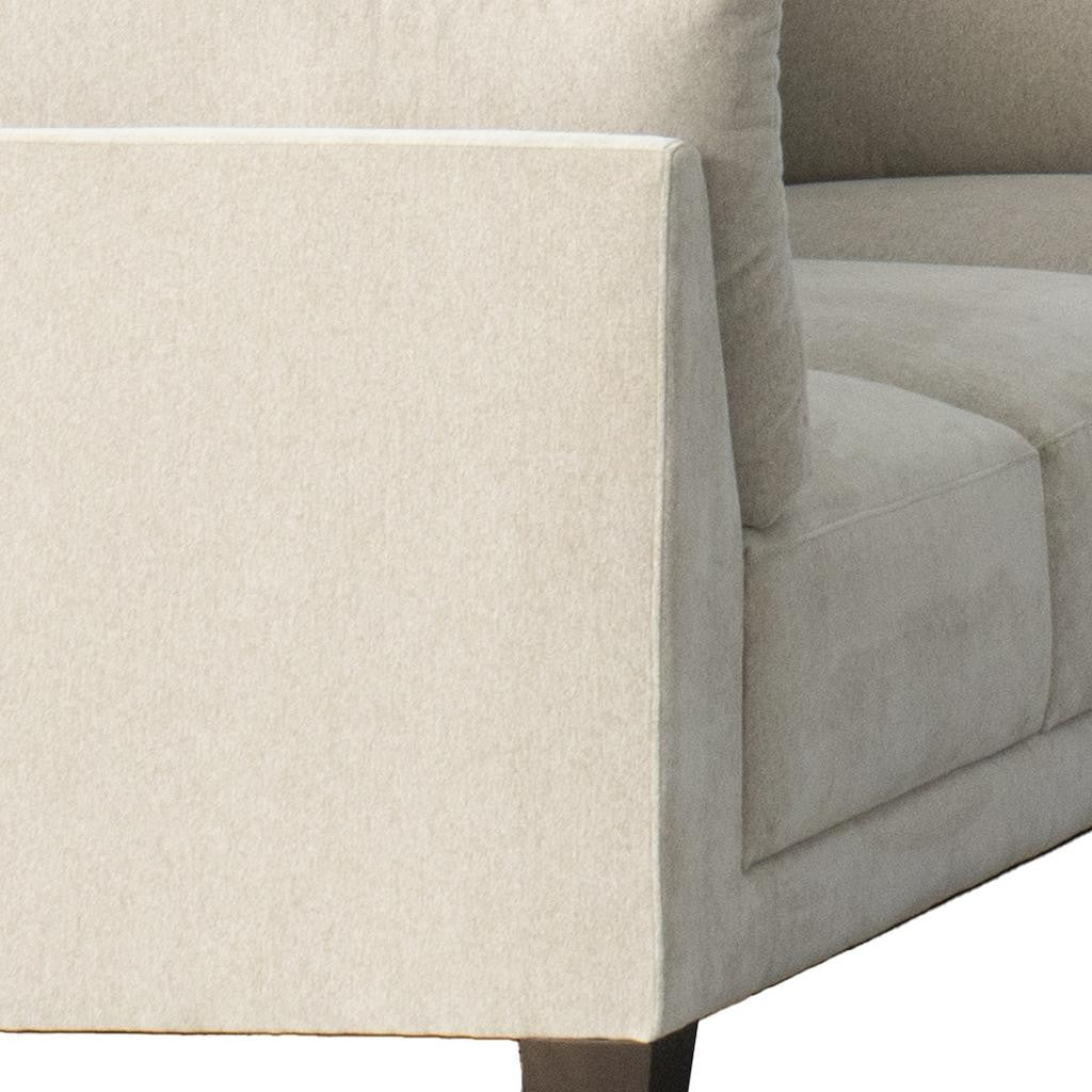 Side angle of Beige Canvas Reclining Sectional with Toss Pillows