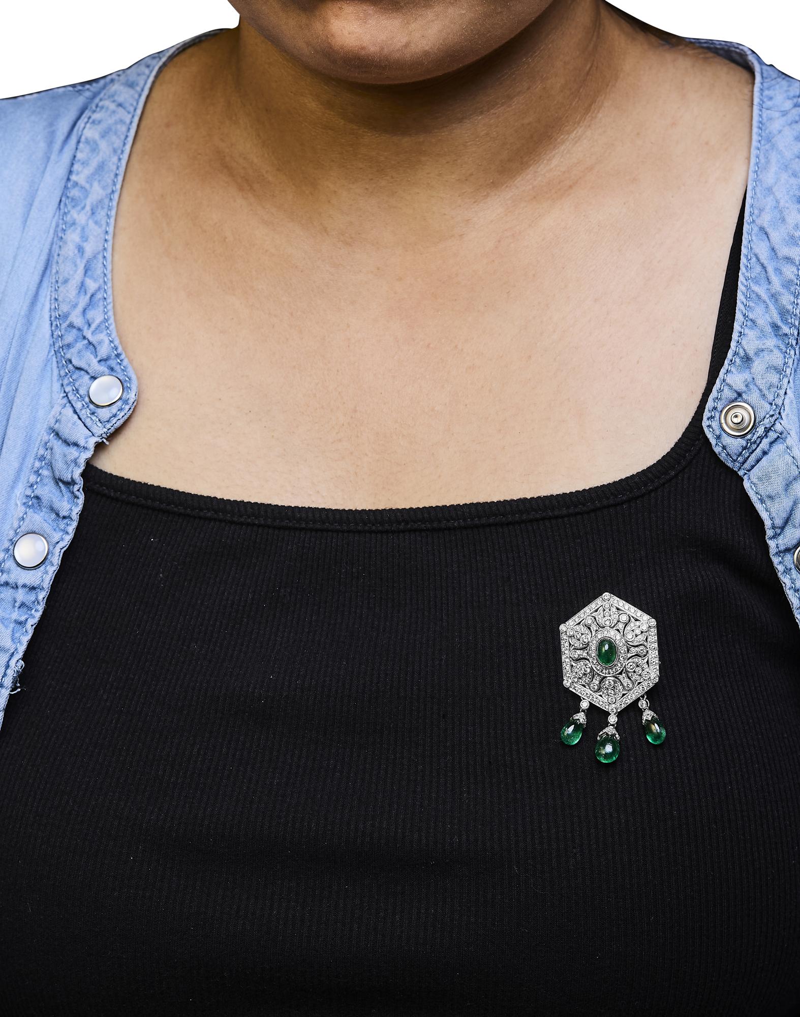 Lifestyle image of the 18K Art Deco Diamond & Emerald Brooch worn elegantly
