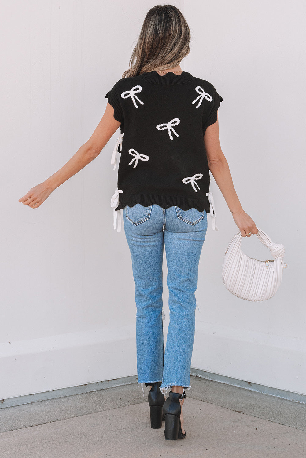 Side view showcasing adjustable ties of Dayana Bow Print Sweater Top