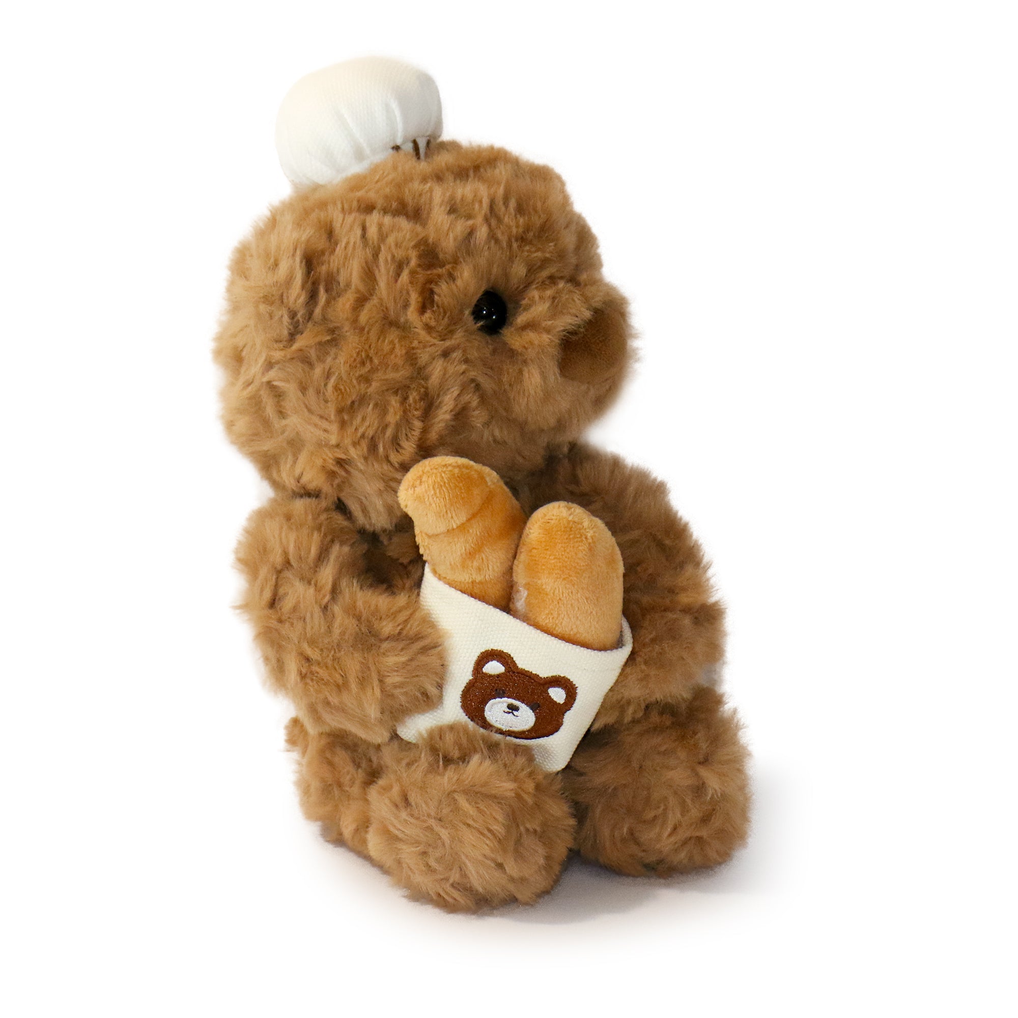 Baker Bear plush toy in a cozy baking-themed setting