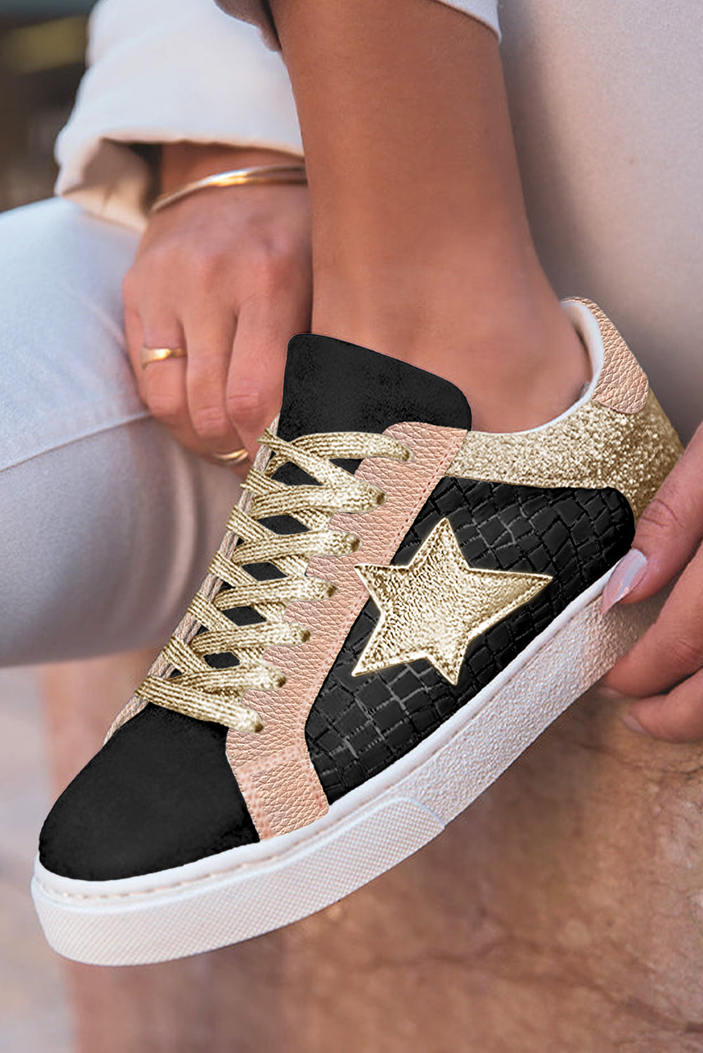 Model wearing Shimmering Gold Star Lace-Up Sneakers in casual outfit