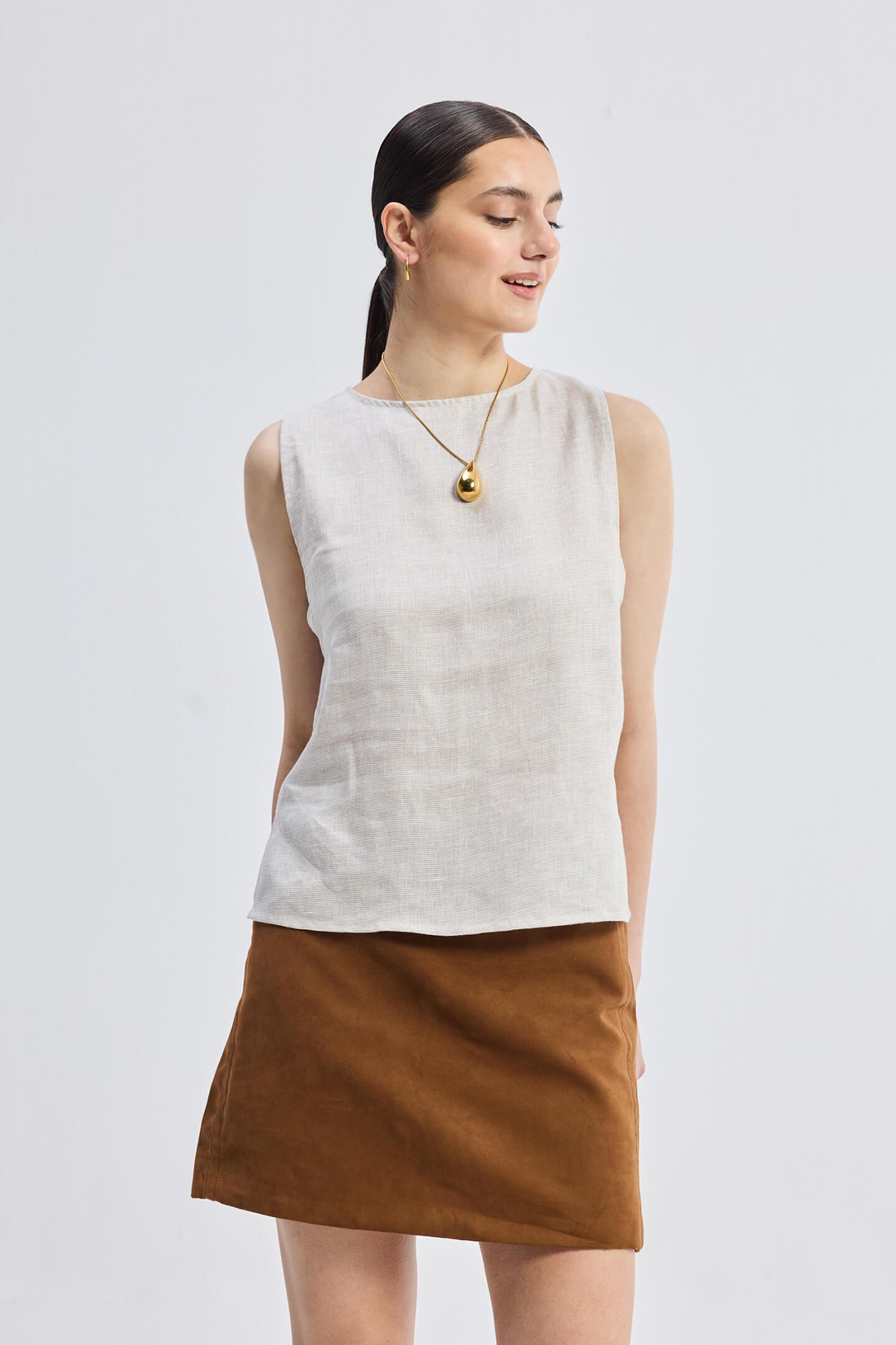 Side view showcasing the cut-outs of Checkered Linen Boat Neck Top