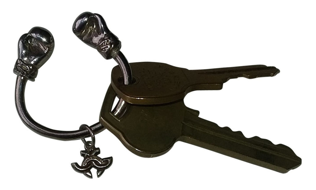 18K Gold Boxing Glove Key Ring being held in a hand