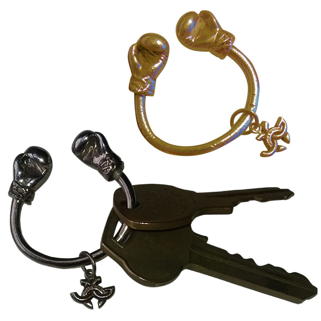 18K Gold Boxing Glove Key Ring with a blurred background