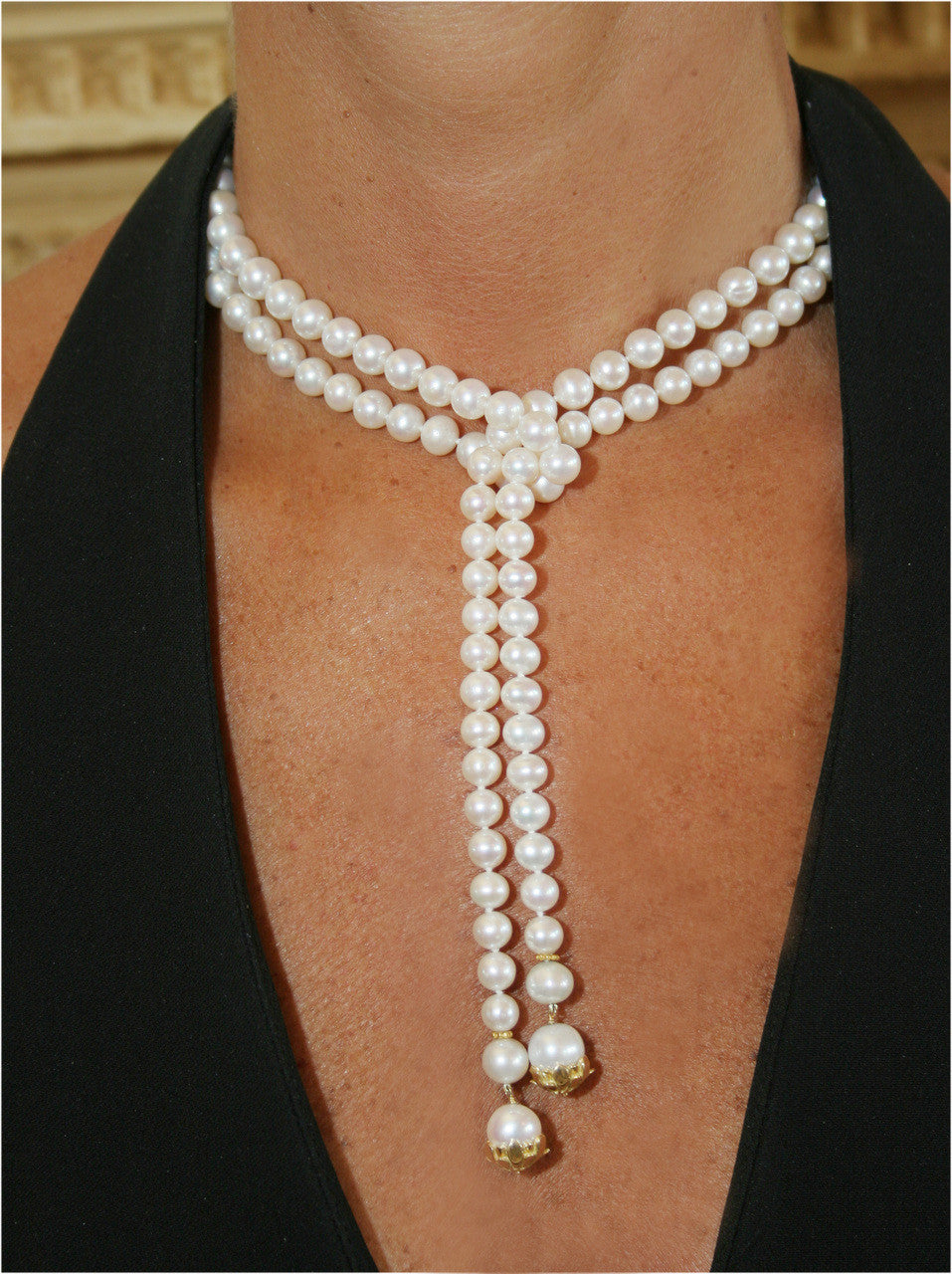 Front view of Customizable Elegant Pearl Lariat with gold flower caps