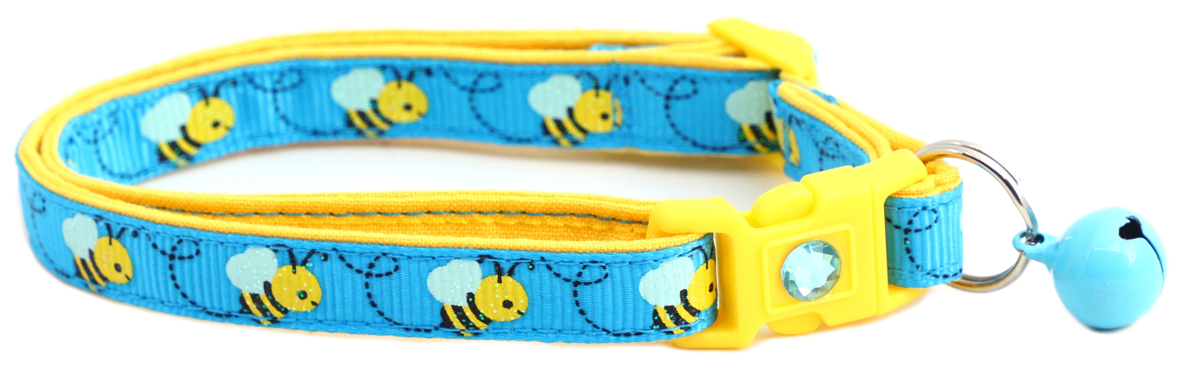Handmade Honey Bees Breakaway Collar placed on a cat bed