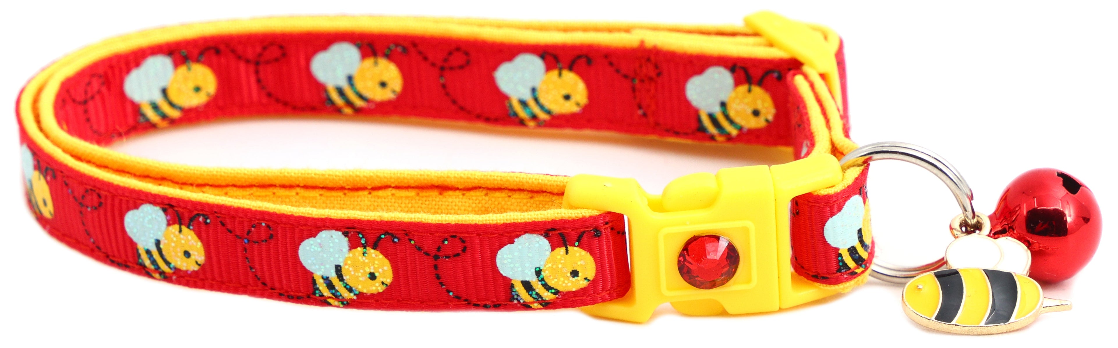 Cats playing together, one wearing Handmade Honey Bees Collar