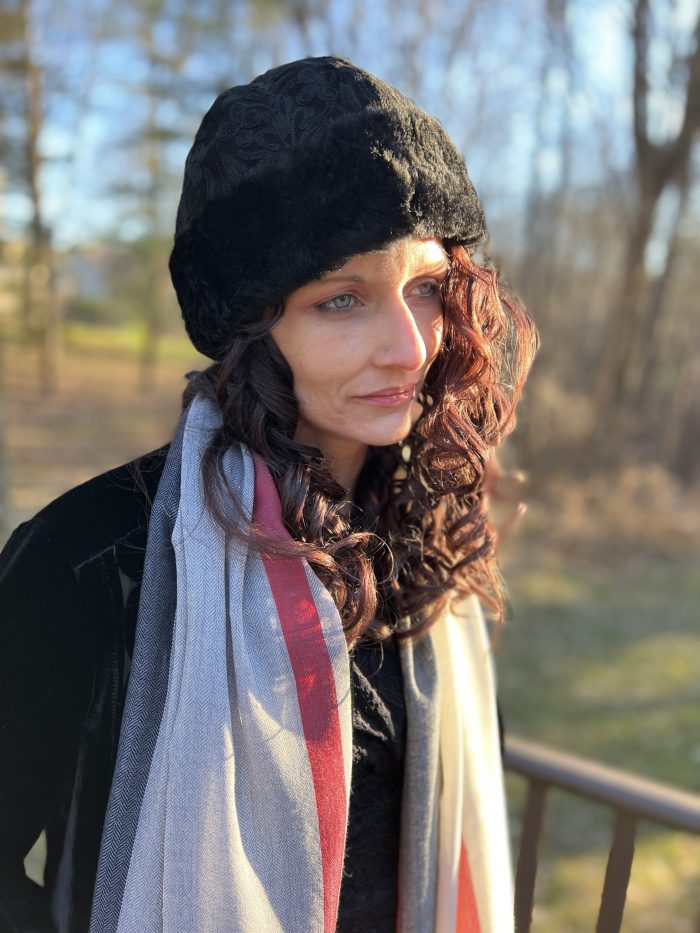 Artisan-crafted black suede hat displayed on a model by Gobingya