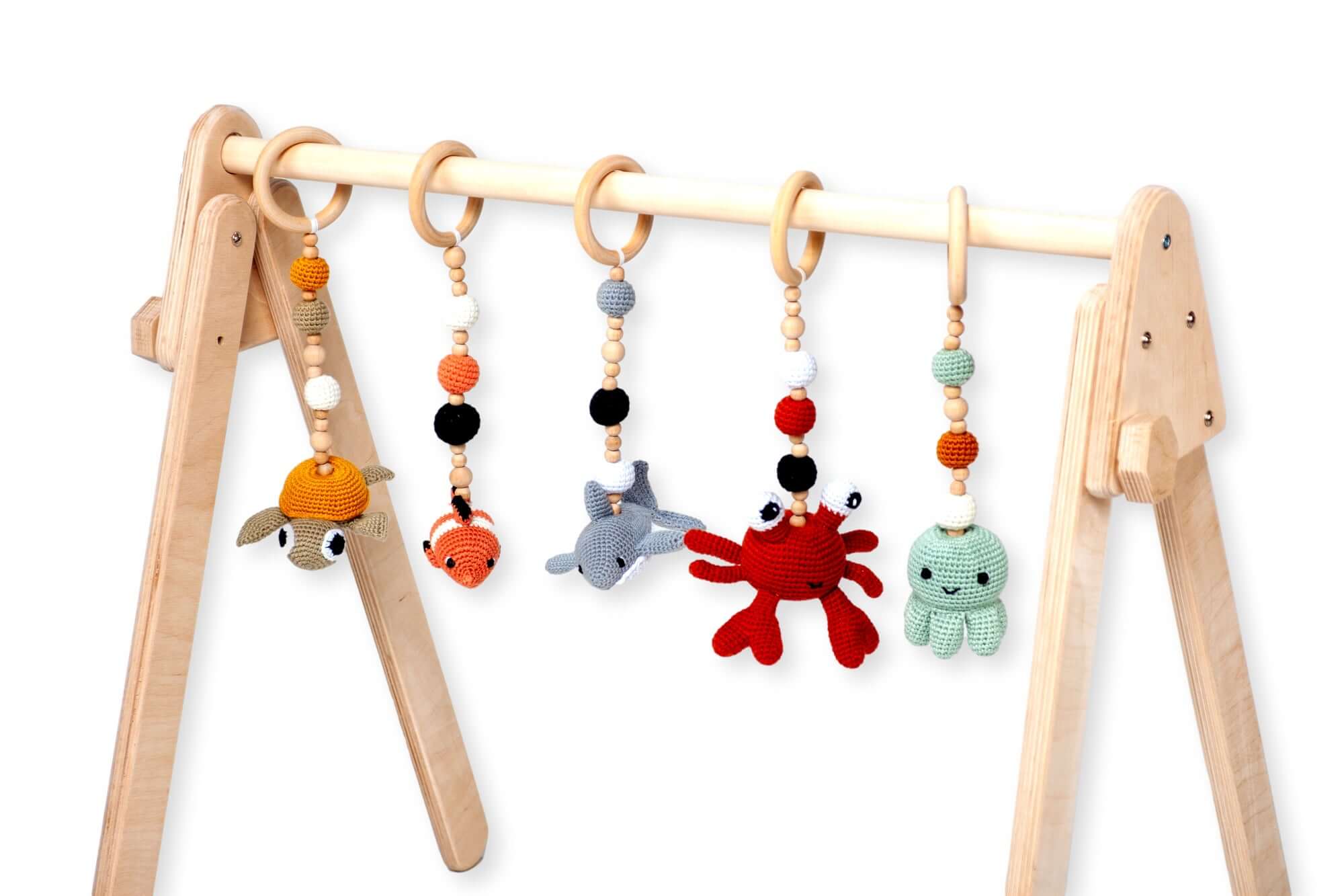 Flat lay of crochet toys included with the Montessori Baby Play Gym