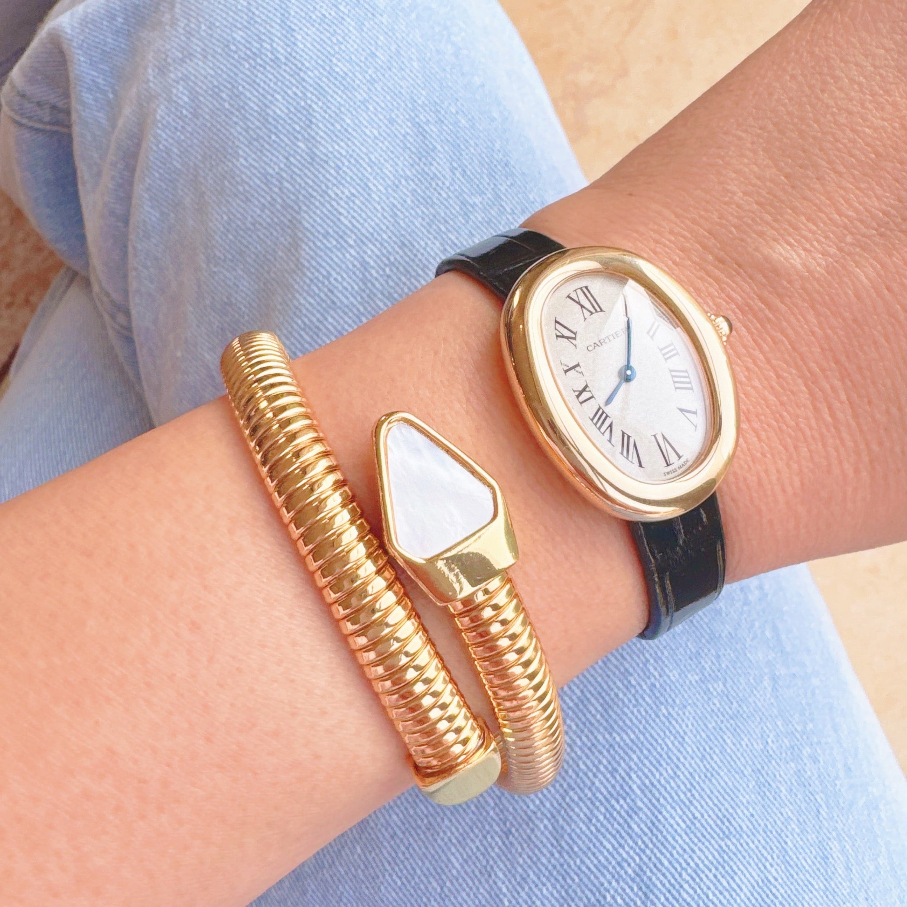 Lifestyle image of Viper Golden Coil Bangle Bracelet worn with other accessories