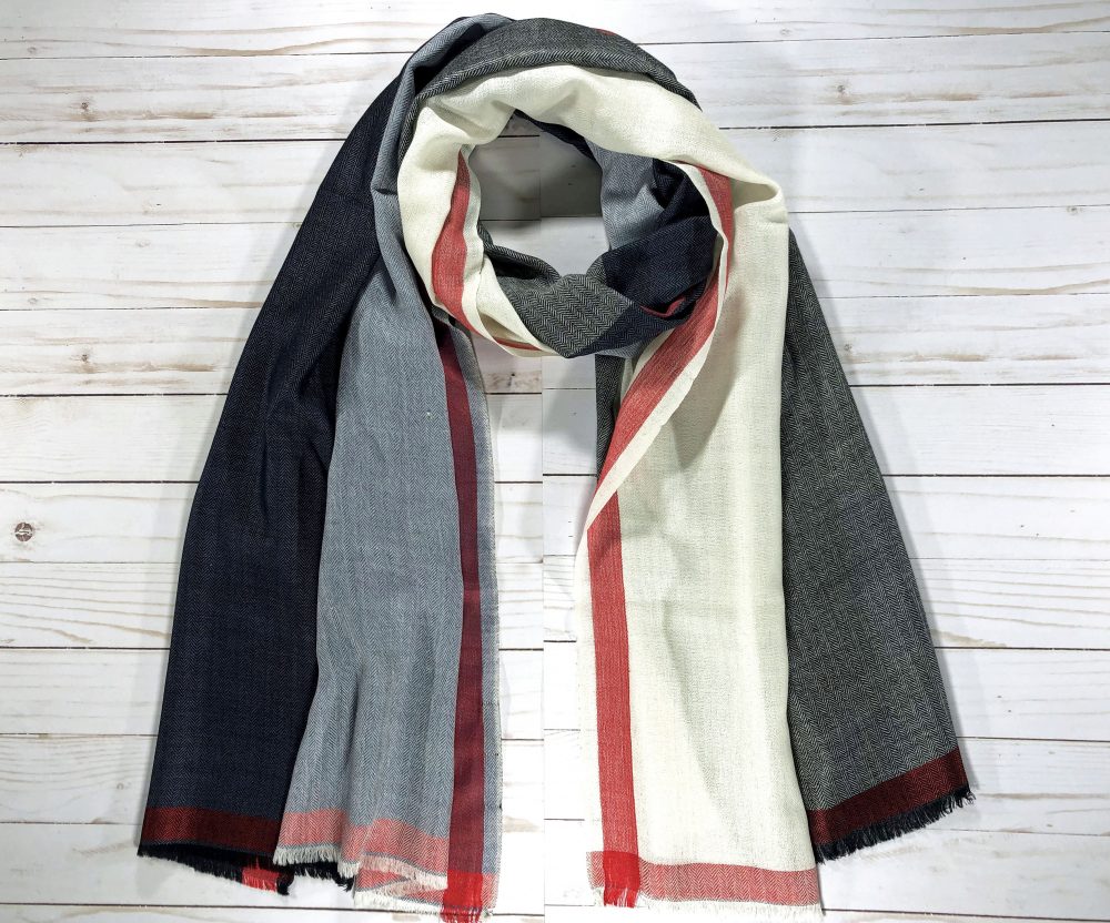 Black and White Plaid Wool & Silk Scarf draped over a stylish coat