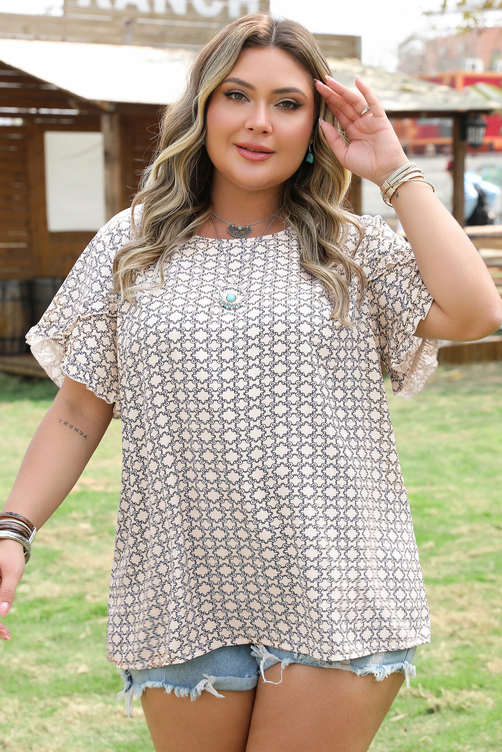 Model wearing Plus Size Geometric Ruffled Sleeve Blouse in a stylish outfit