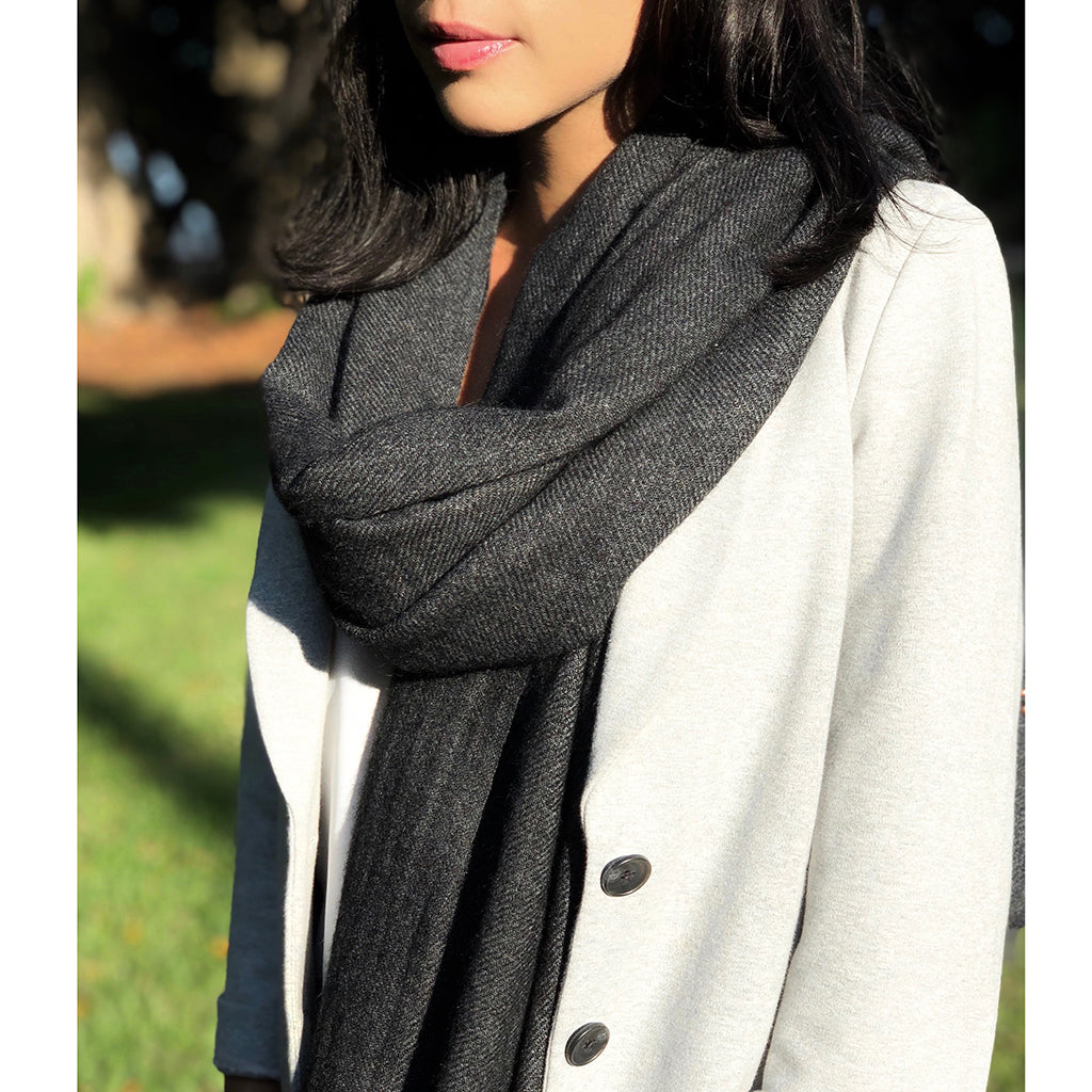 Model showcasing the black handloom cashmere scarf styled for layering