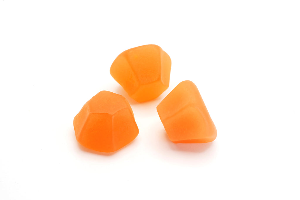 Group of Hair, Skin & Nails Gummies displayed with fresh fruits for a vibrant look