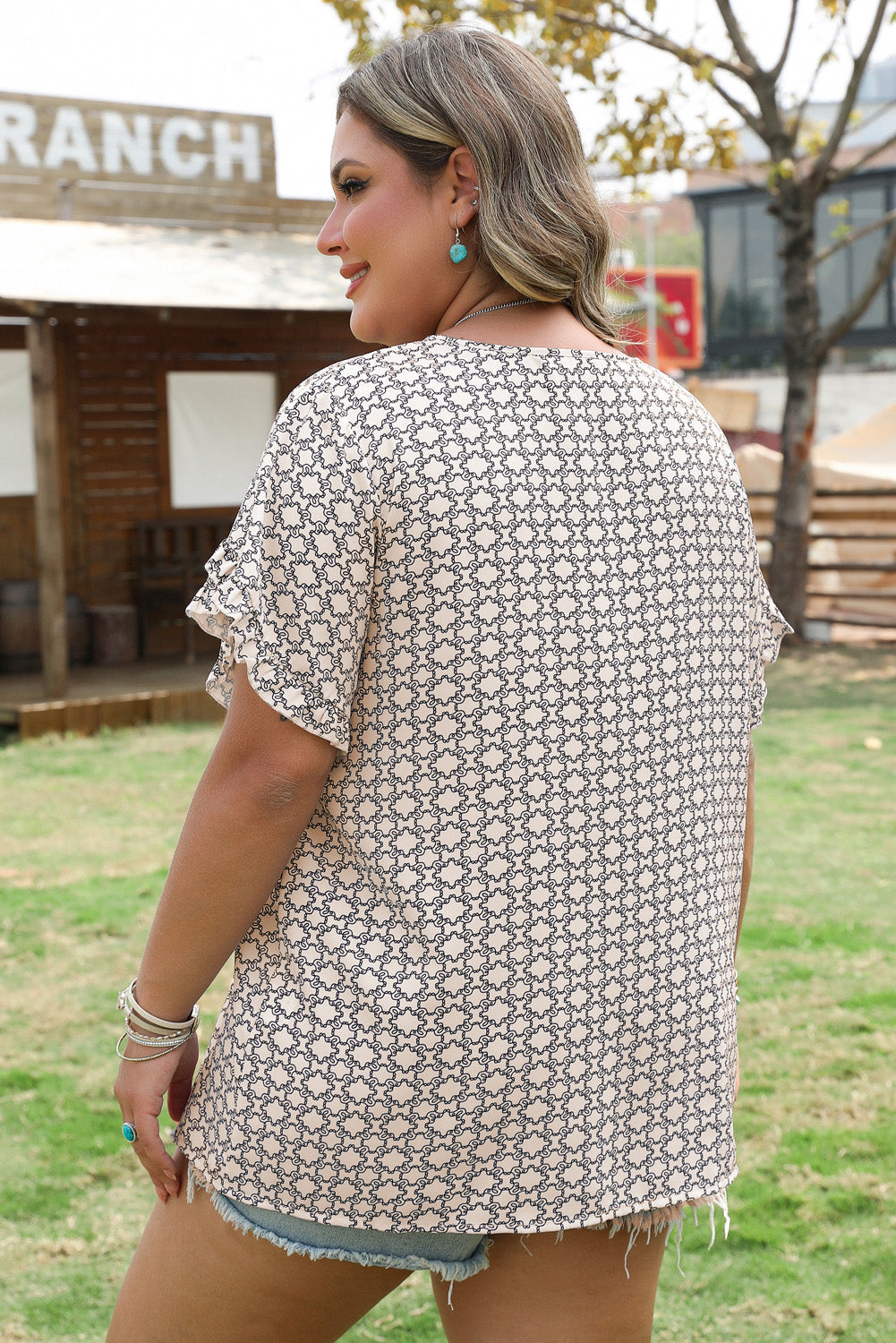 Side view showcasing the ruffled sleeves of Plus Size Blouse by Threaded Pear