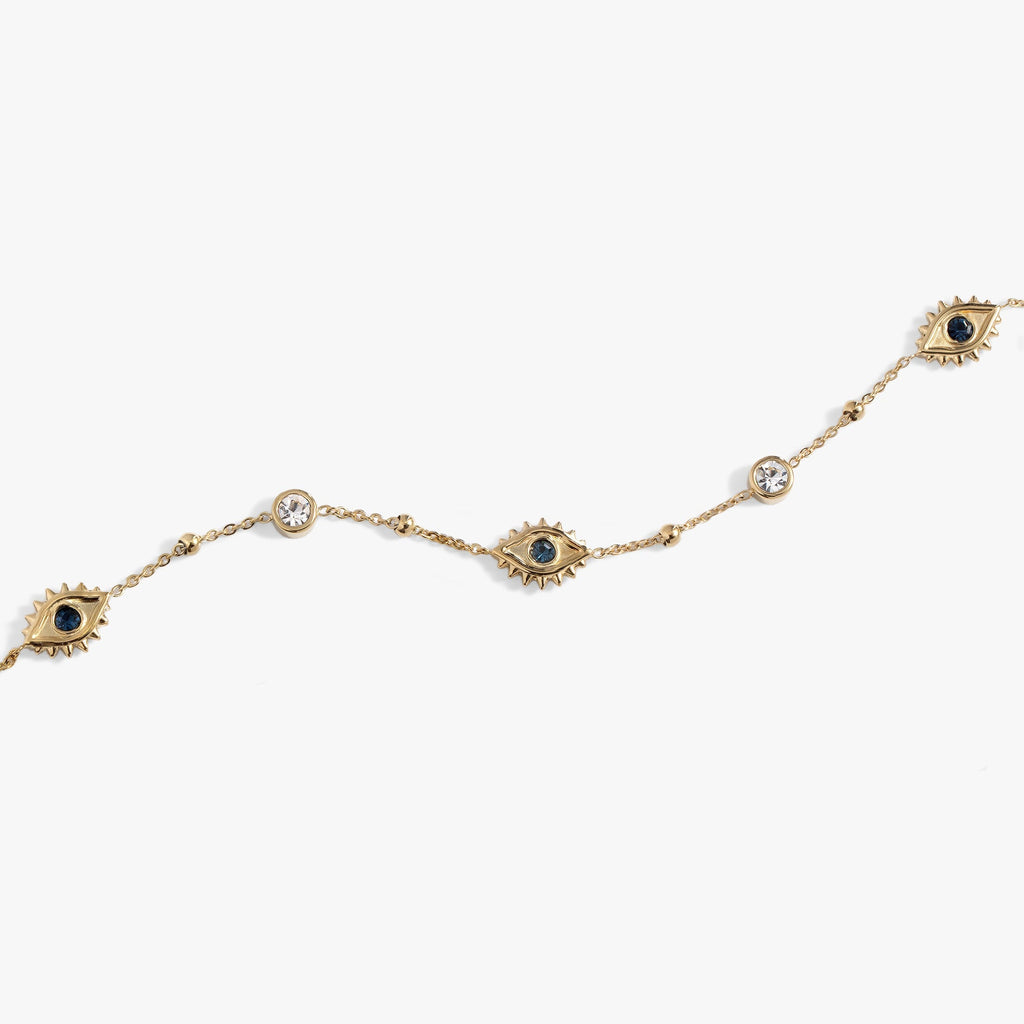 Flat lay of Evil Eye Crystal Anklet on a vibrant summer background