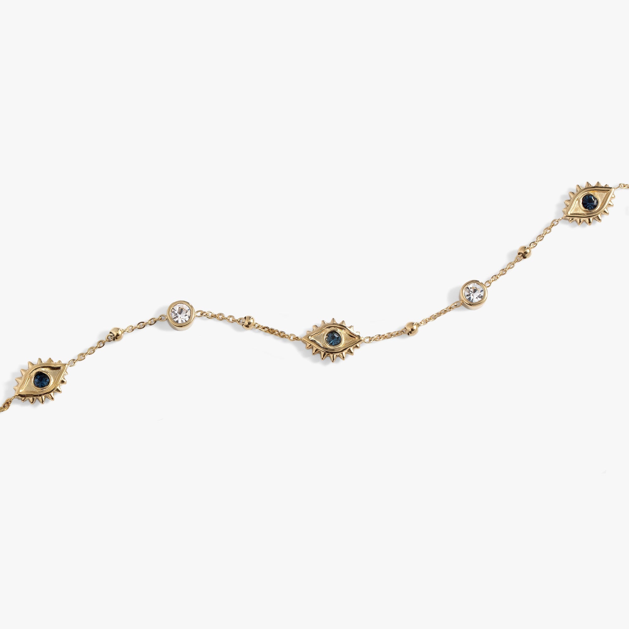 Flat lay of Evil Eye Crystal Anklet on a vibrant summer background