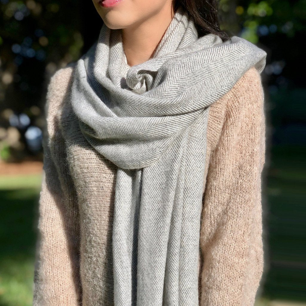 Lifestyle shot of person wearing Gray Herringbone Cashmere Scarf outdoors