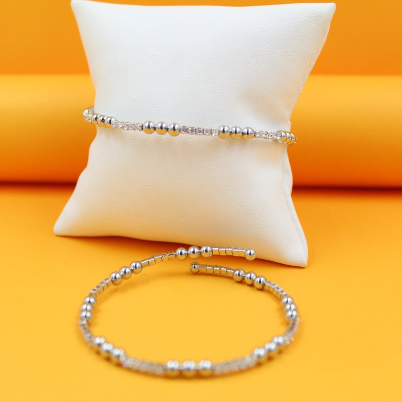 Close-up view of the luxurious 18K Rhodium Triple Bead Bracelet