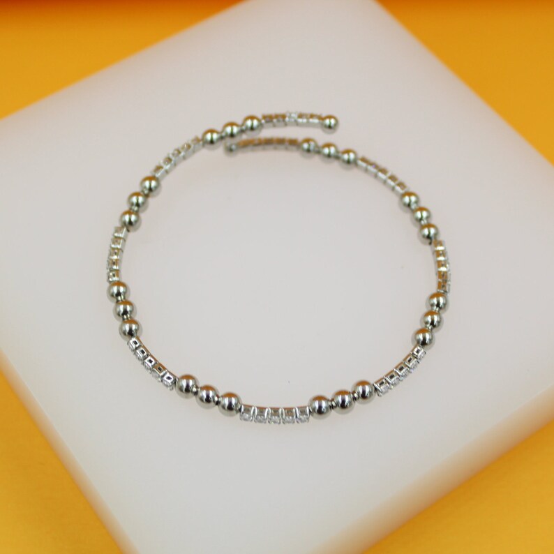 Elegant 18K Rhodium Triple Bead Bracelet by MIA Jewelry on display
