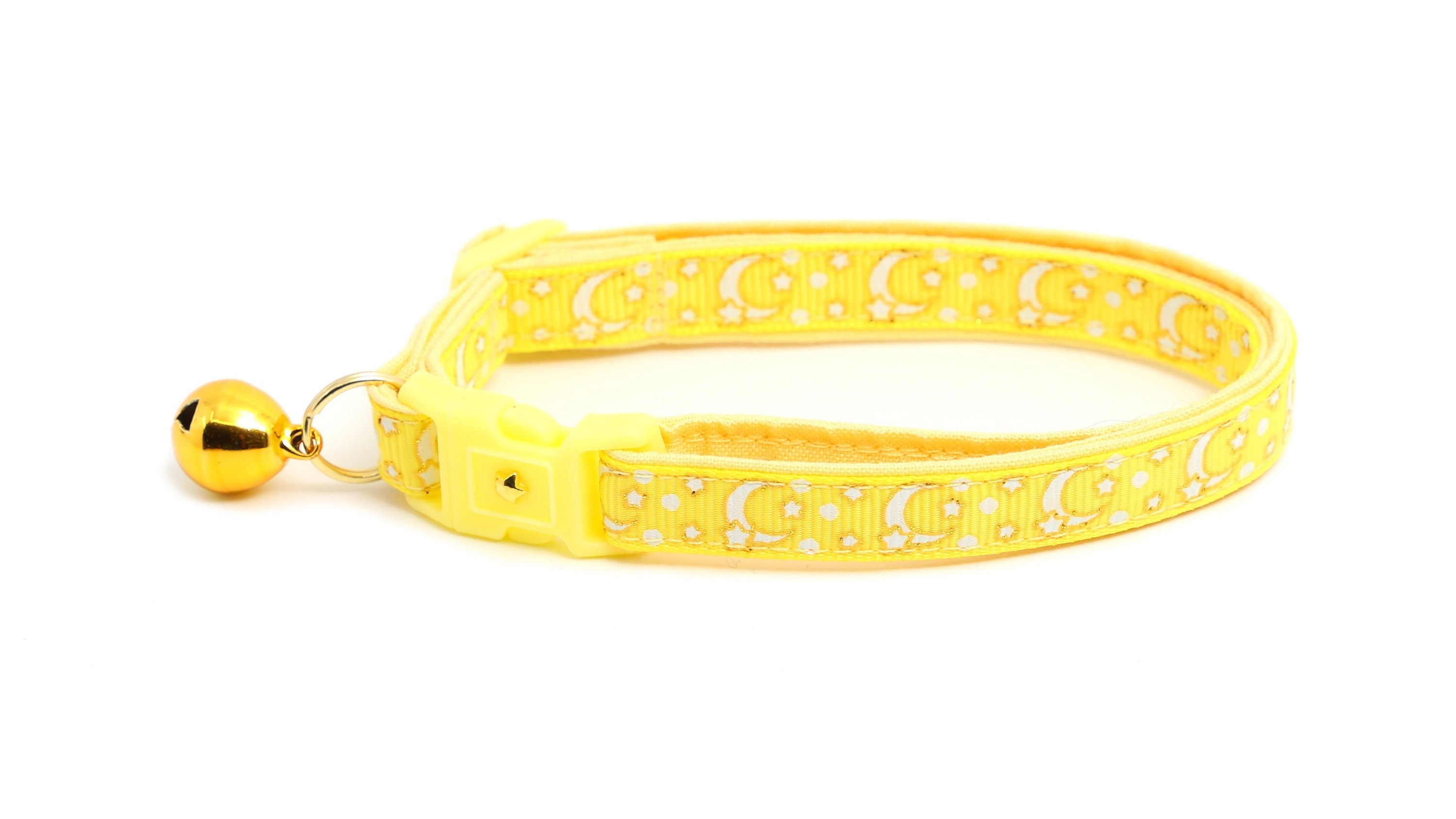 Side view of stylish yellow cat collar with celestial design