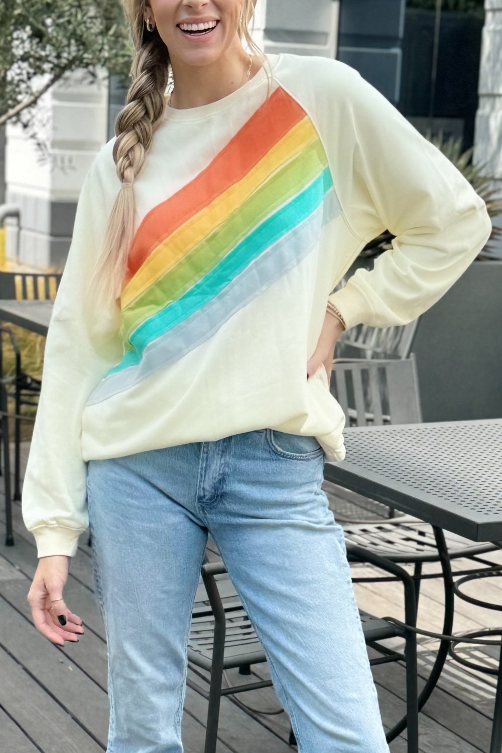 Front view of Penelope Striped Pullover Sweatshirt in rainbow colors by Threaded Pear
